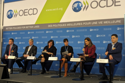 People sitting on panel at OECD
